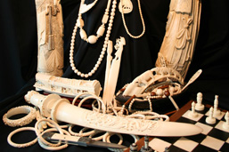Objects made from elephant ivory: sculptures, bracelets, necklaces, chess pieces and board, paper cutters, chopsticks, ivory utensils and toothbrushes.